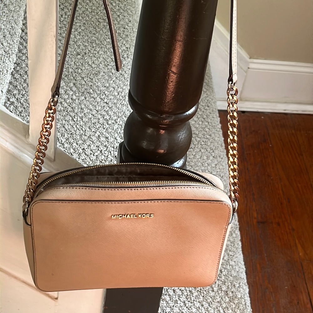 Uses Michael Kors crossbody Purse .